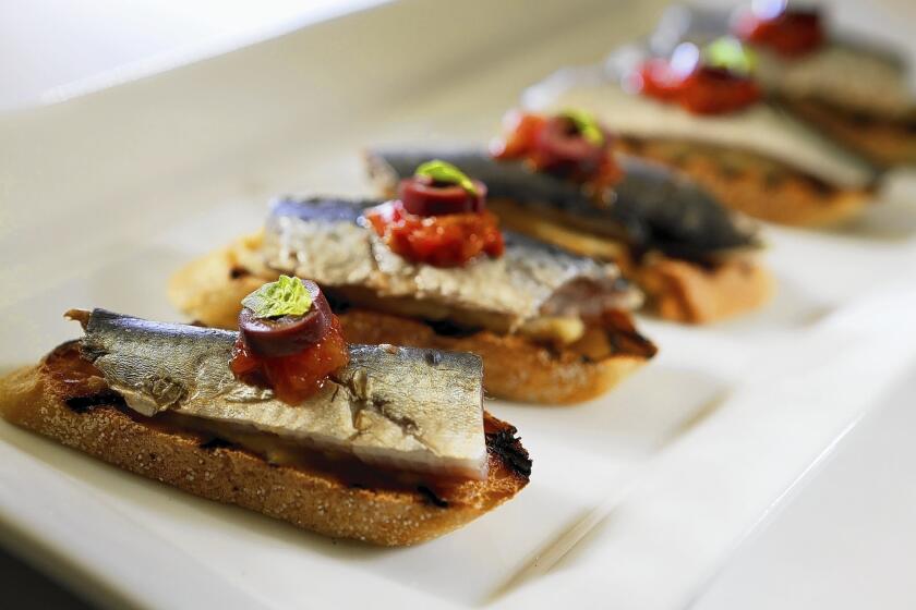 Lightly salted and pickled sardines on toasted baguette with artichoke puree, tomato and black olive.