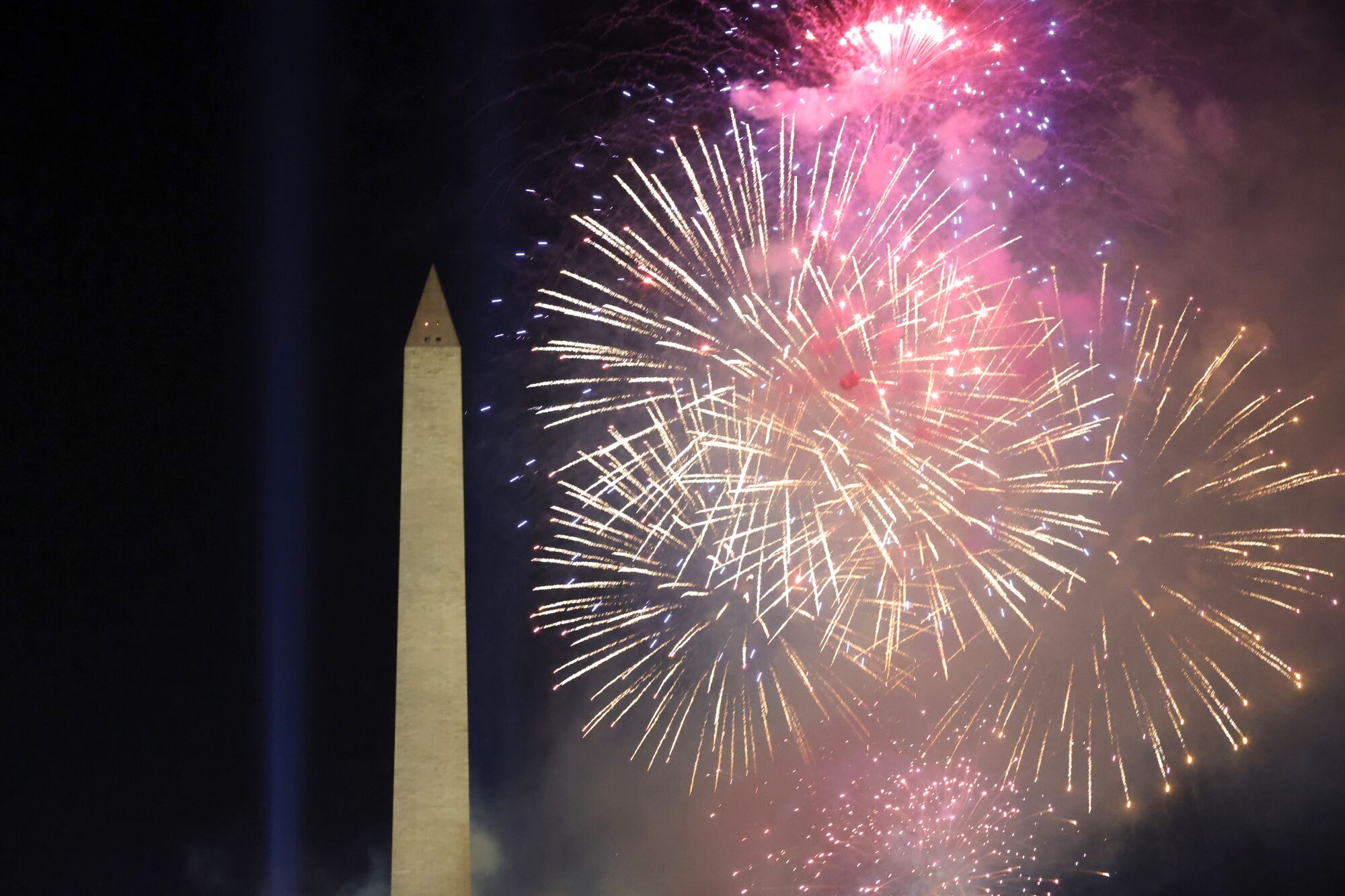 Fireworks frame the Washington Monument during an Inauguration Day event at the Lincoln Memorial.