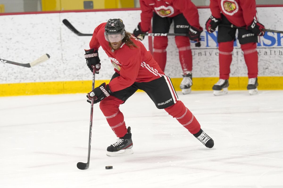 Chicago Blackhawks' Duncan Keith handles the puck during an NHL hockey training camp practice Monday, Jan. 4, 2021, in Chicago. (AP Photo/Charles Rex Arbogast)