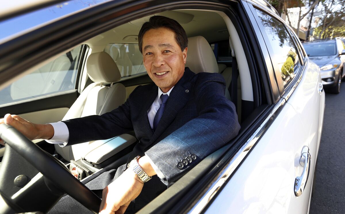 Masamichi Kogai, president and CEO at Mazda Global Motor Corp., is seen in a new Mazda at the Los Angeles Times.
