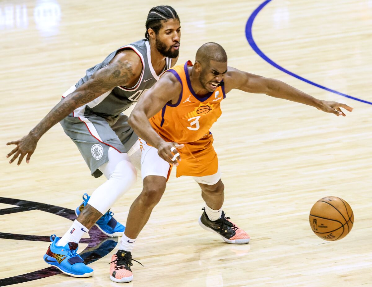 Clippers forward Paul George disrupts the dribble of Suns guard Chris Paul during Game 4.