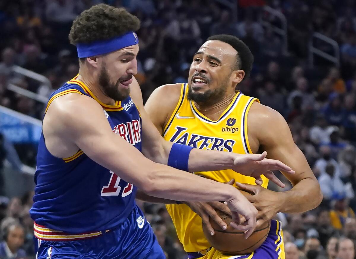 Lakers guard Talen Horton-Tucker is fouled by Golden State Warriors guard Klay Thompson.