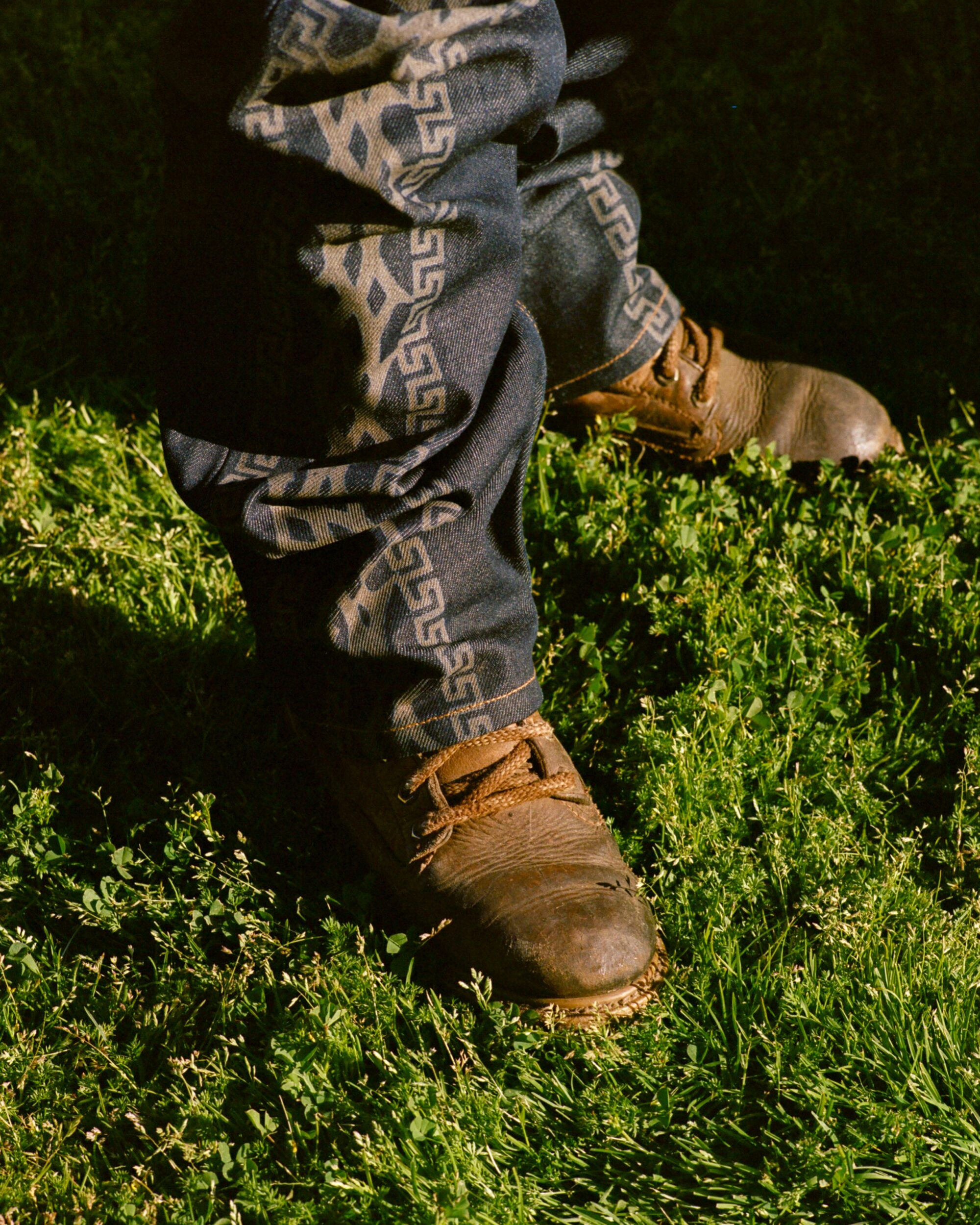 Denim jeans and boots on grass.