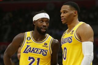 Laker guards Patrick Beverley, left, and Russell Westbrook talk during a break in the action