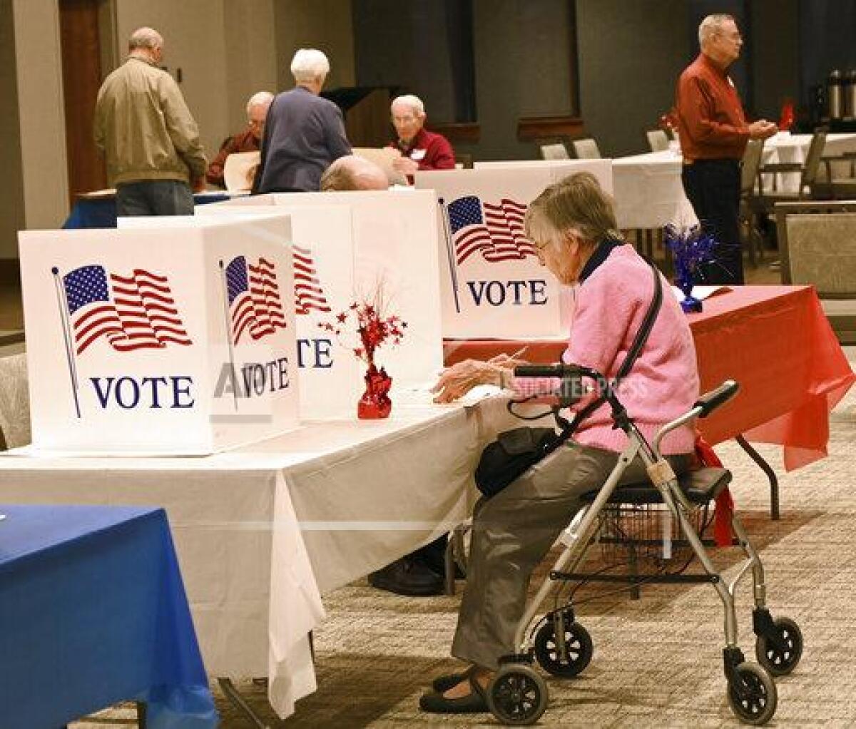 A voter fills out a ballot in a special election primary in February in Baltimore. The general election to determine who will replace the late Rep. Elijah Cummings is Tuesday.