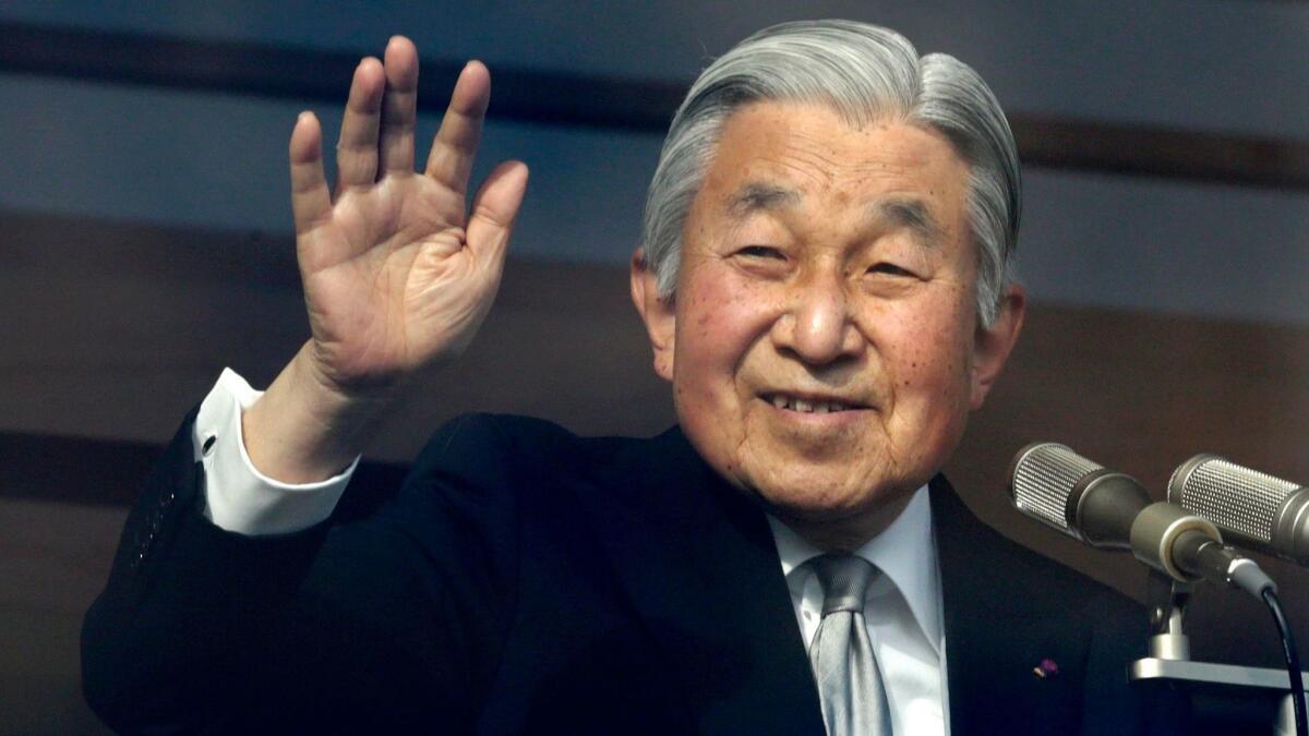 Japanese Emperor Akihito waves to well-wishers after delivering a speech marking his 85th birthday at the Imperial Palace in Tokyo on Dec. 23, 2018.