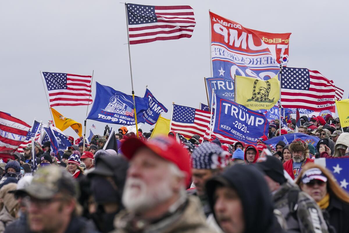 Trump supporters holding flags at a rally in Washington on Jan. 6, 2021.
