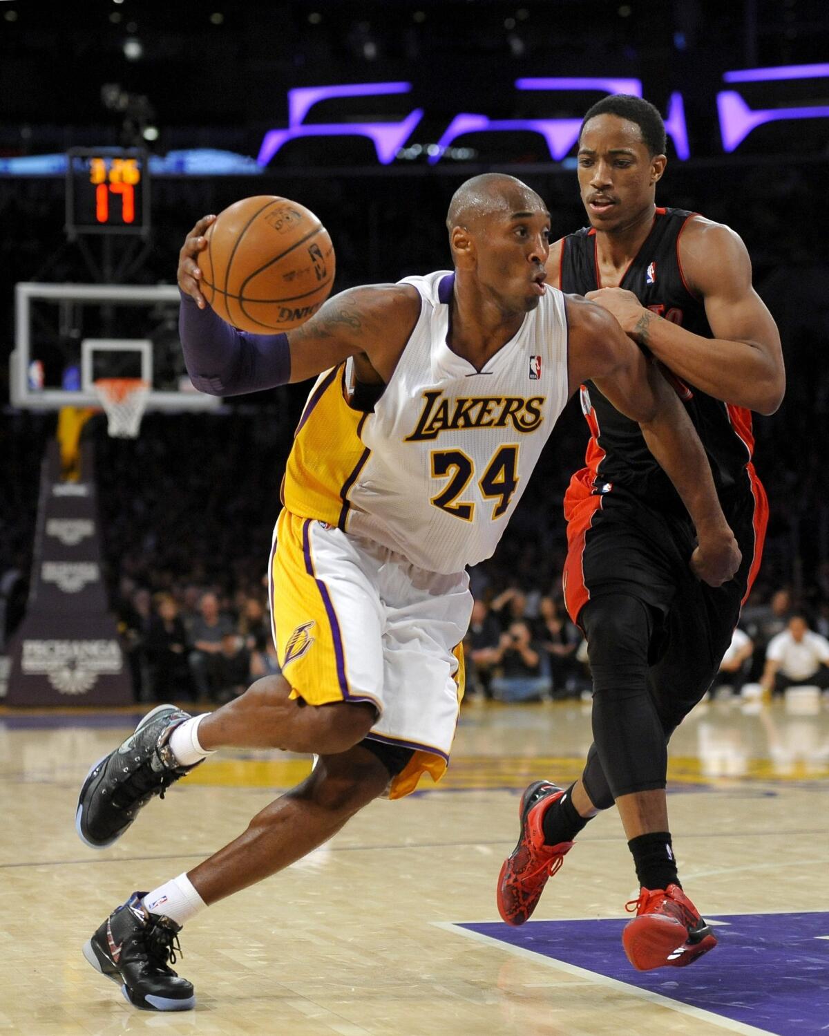 Lakers star Kobe Bryant, left, drives past Toronto's DeMar DeRozan during the Lakers' 106-94 loss Sunday night at Staples Center.