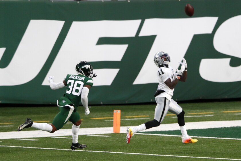 Las Vegas Raiders' Henry Ruggs III, right, catches a touchdown during the second half an NFL football game against the New York Jets, Sunday, Dec. 6, 2020, in East Rutherford, N.J. (AP Photo/Noah K. Murray)