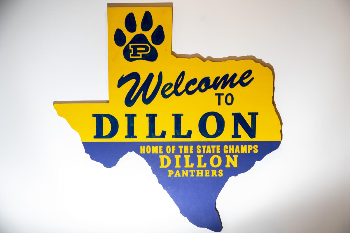 A sign in the shape of Texas reads: "Welcome to Dillon: Home of the state champs Dillon Panthers"
