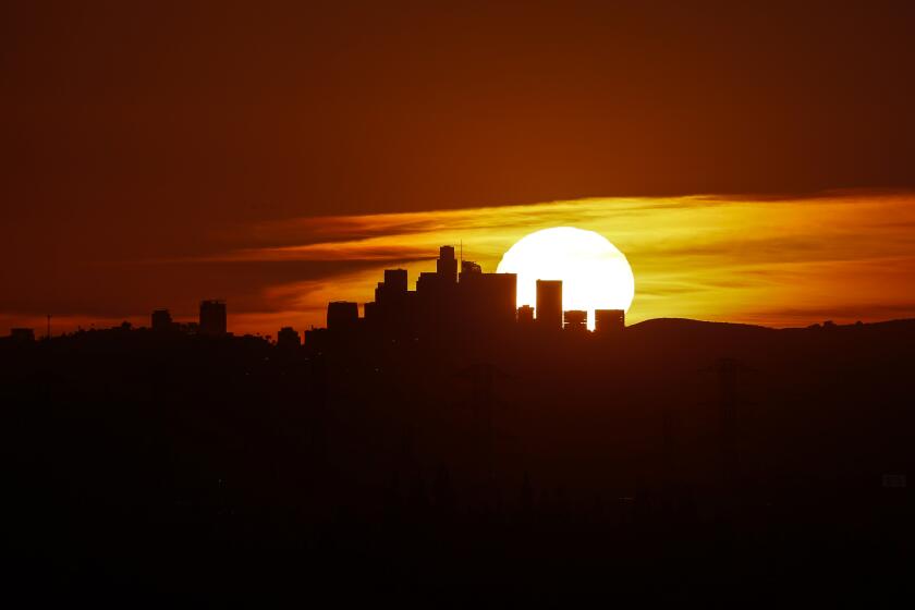 Azusa, CA, Friday, February 9, 2024 - The sun sets behind the LA skyline as seen from Azusa. (Robert Gauthier/Los Angeles Times)