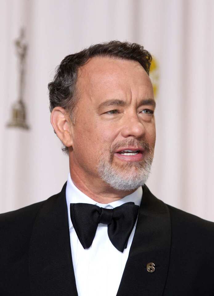 Tom Hanks' "6" lapel pin. No one is sure what it means, but it proves that what a man wears on his lapel can cause quite a conversation.
