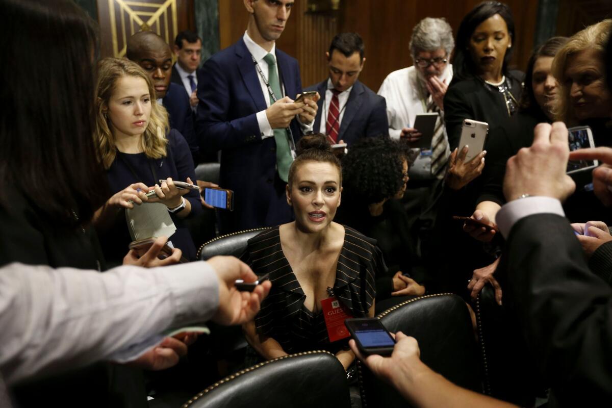 Actress Alyssa Milano talks to media before attending the Senate Judiciary Committee hearing.