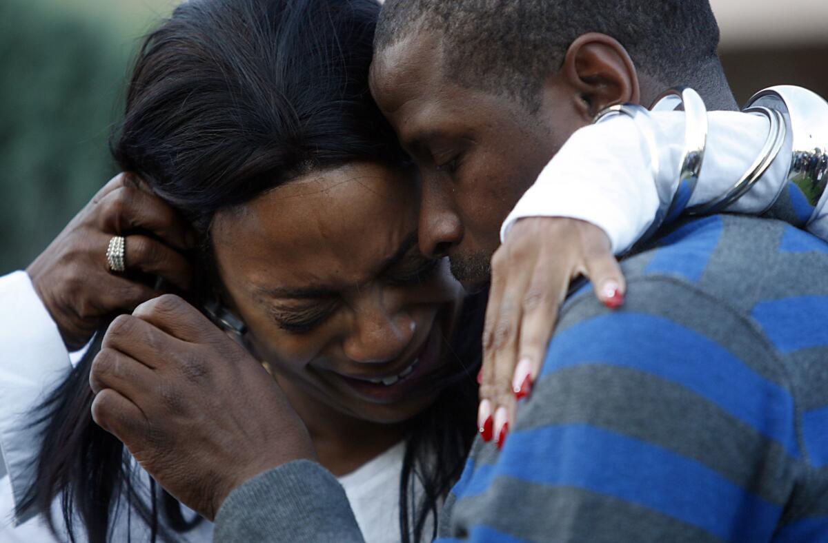 Kim Evans is comforted by Christopher Jackson in December 2010 as they announce a $75,000 reward for information leading to the arrest and conviction of individuals involved in the Christmas Day murder of her daughter, Kashmier James, 25, in South Los Angeles.