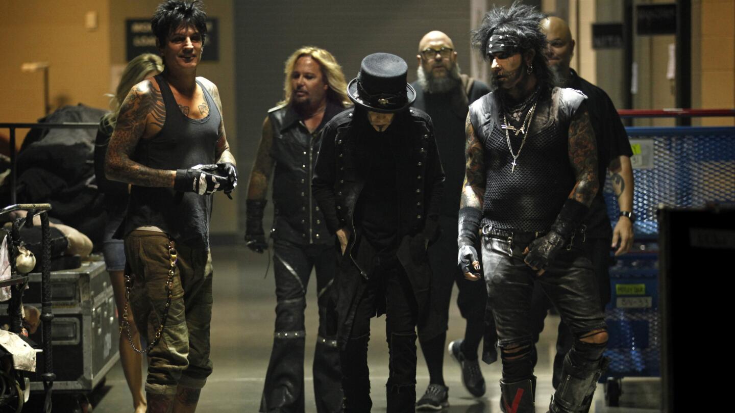 Mötley Crüe's Tommy Lee, left, Vince Neil, Mick Mars and Nikki Sixx make their way down a corridor before the start of their concert at the Matthew Knight Arena in Eugene, Ore., on July 22, 2015.