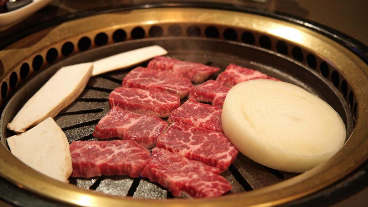 The servers cook your kkot sal (slices of "flower" meat) on the grill for you at Ombu Grill in Koreatown.