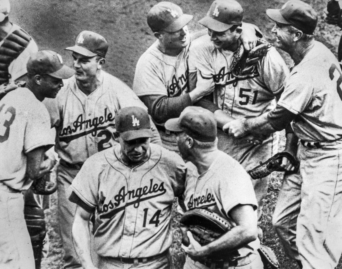 Dodgers reliever Larry Sherry, upper right, is congratulated by teammates after a victory over the Chicago White Sox.