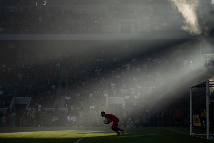 Los Angeles FC goalkeeper Maxime Crépeau catches a shot during the first half of an MLS soccer match against the LA Galaxy in Los Angeles, Friday, July 8, 2022. (AP Photo/Kyusung Gong)