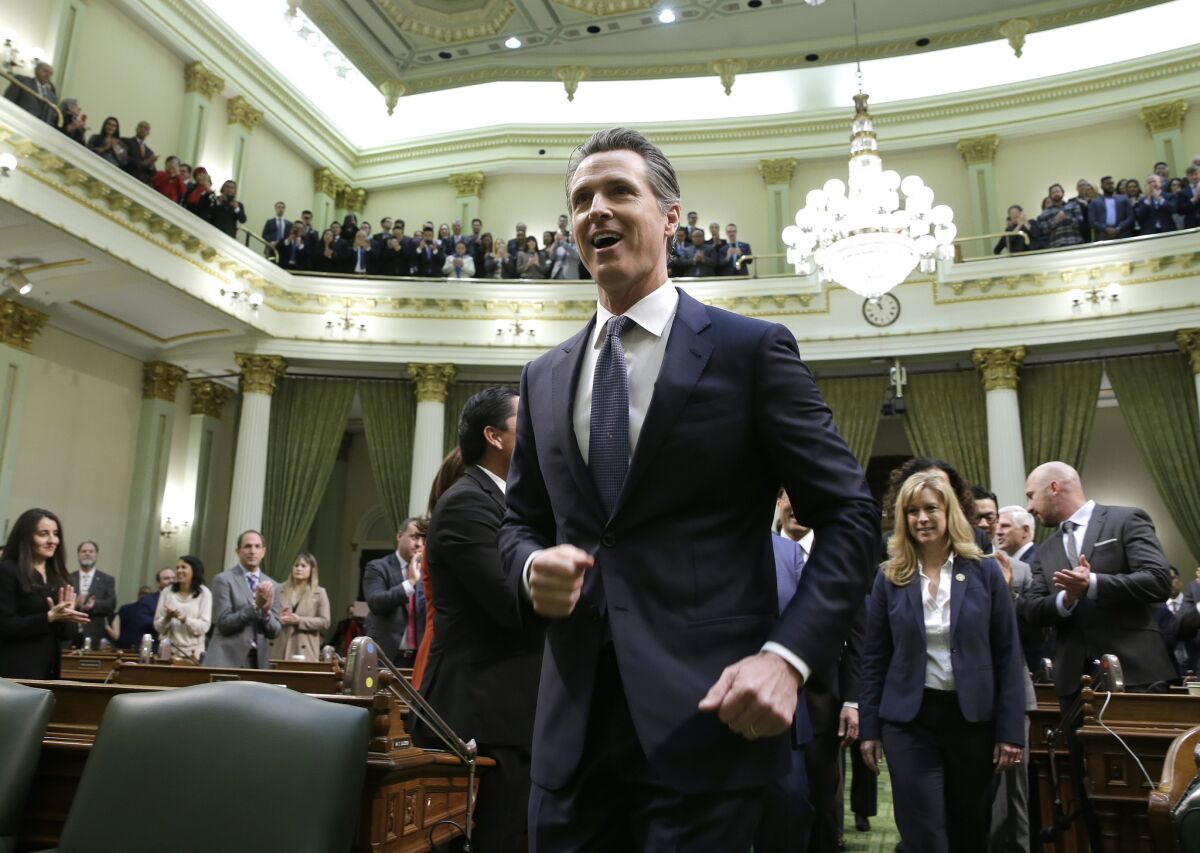 Gavin Newsom walks up up the center aisle of the Assembly Changers to deliver his first of the state address to a joint session of the legislature at the Capitol Tuesday, Feb. 12, 2019, in Sacramento, Calif. (AP Photo/Rich Pedroncelli)