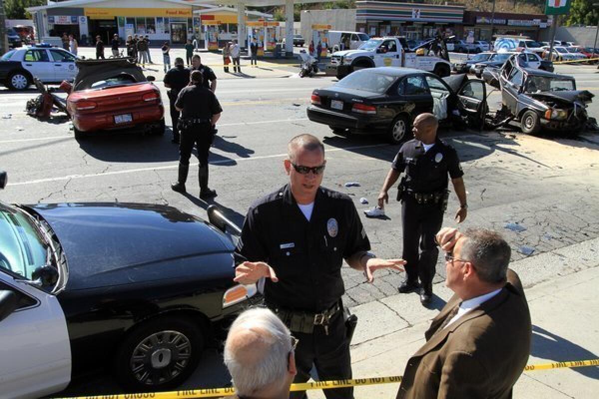 Police investigators work at the scene of a multi-vehicle hit-and-run accident involving four cars at De Soto Avenue and Ventura Boulevard in Los Angeles.