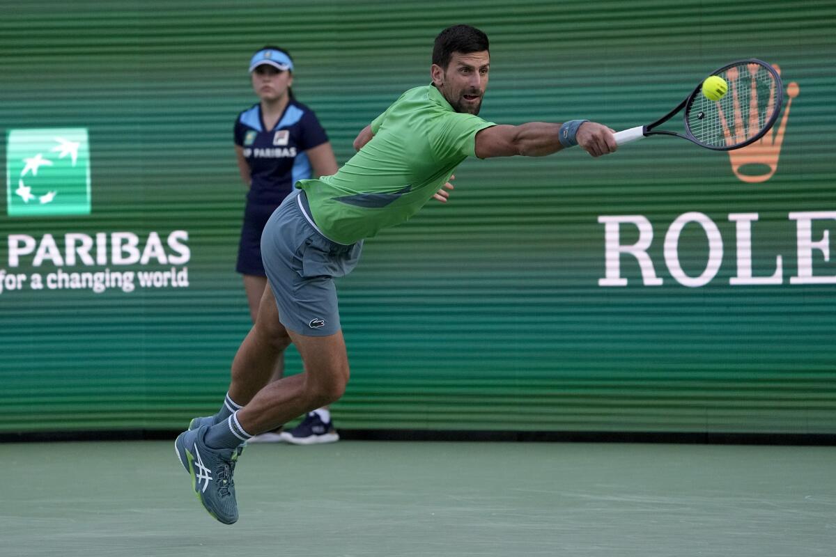 Novak Djokovic hits a backhand return during his victory over Aleksandar Vukic at the BNP Paribas Open.