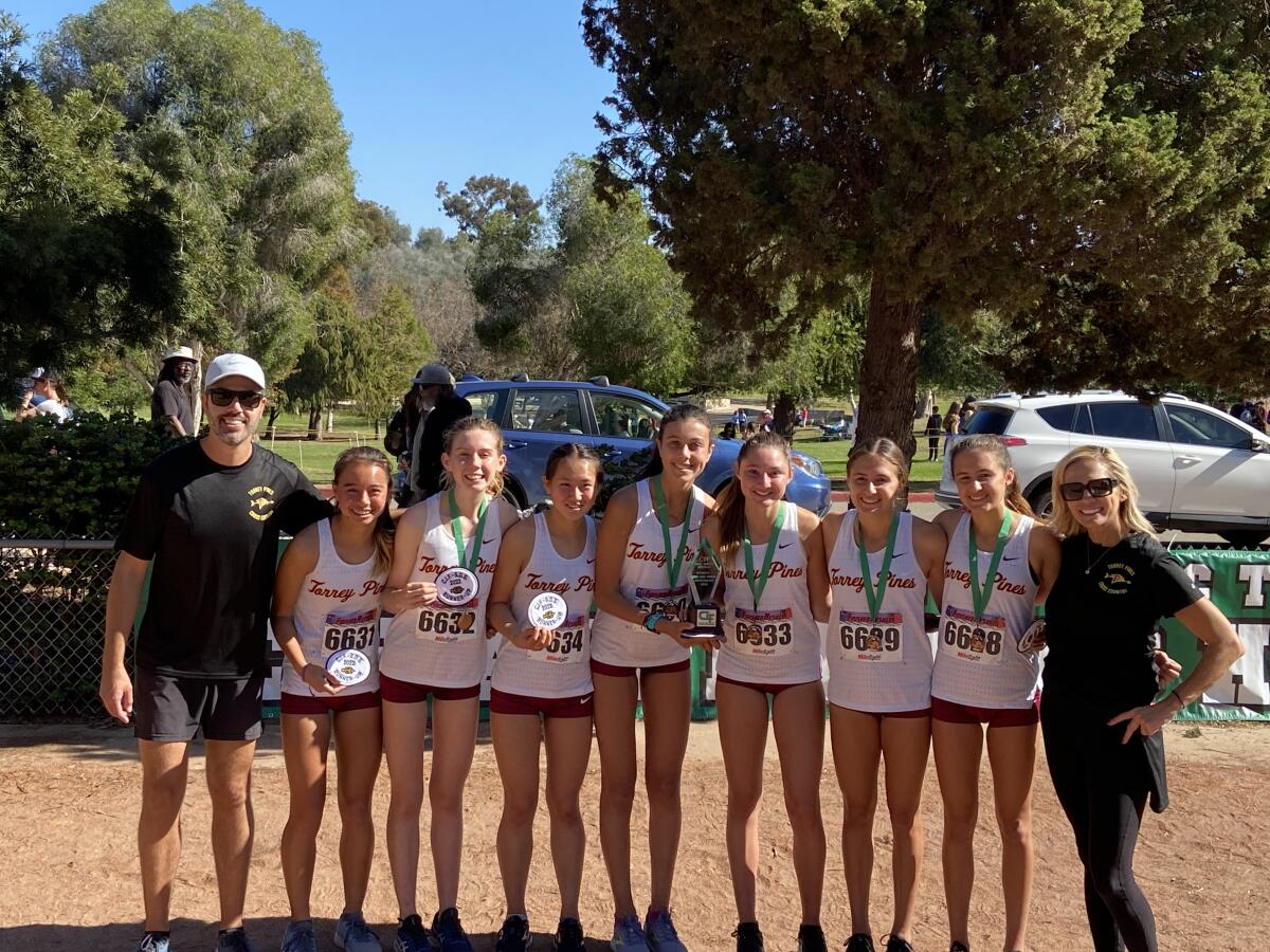 The second place Torrey Pines girls cross country team with Head Coach Jacob Feiring and Assistant Coach Julie Ott.