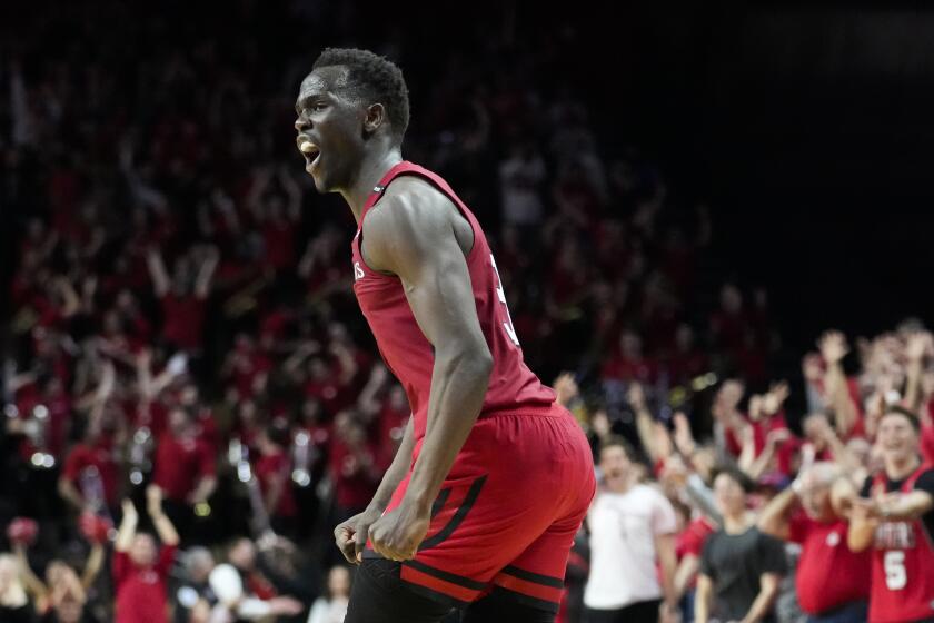 Rutgers' Mawot Mag (3) celebrates after scoring three points to extend their lead over Ohio State in overtime of an NCAA college basketball game, Sunday, Jan. 15, 2023, in Piscataway, N.J. (AP Photo/John Minchillo)