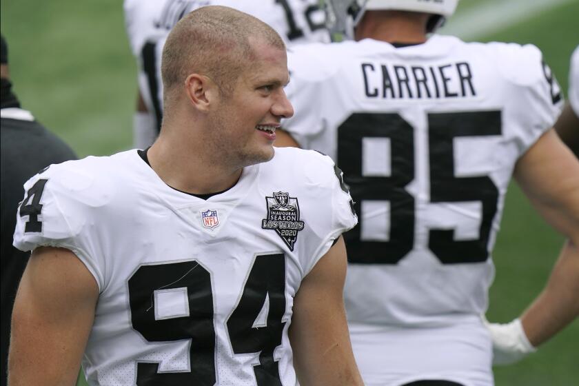 Las Vegas Raiders defensive end Carl Nassib watches from the sideline in the first half.