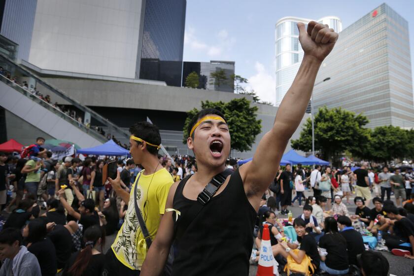 A pro-democracy activist shouts slogans near the government headquarters in Hong Kong where protesters were camped out Oct. 1.