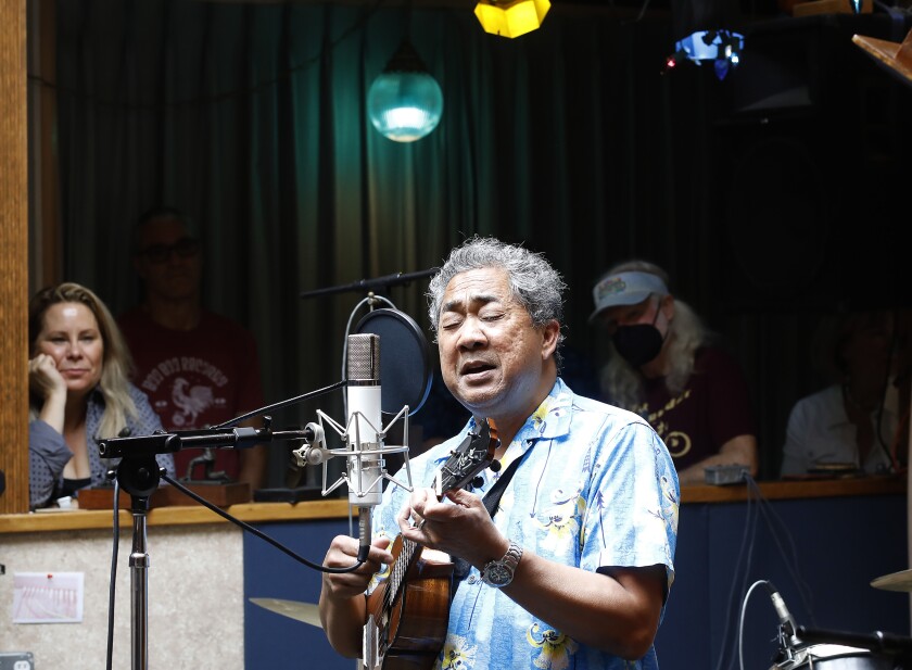 Adrian Demain plays the ukulele and sings at Thunderbird Analog Recording Studio in Oceanside on Sunday.