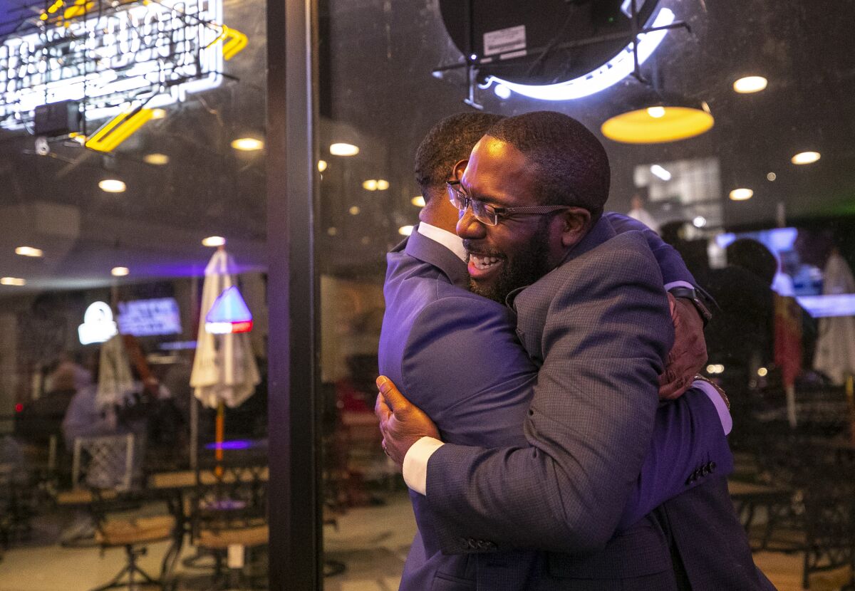 Waterloo Mayor Quentin Hart and campaign consultant Ryan Stevenson embrace as they celebrate after election results showed that Hart won his bid for re-election on Tuesday, Nov. 2, 2021 at the GR Kitchen and Taps in Waterloo, Iowa. (Chris Zoeller/The Courier via AP)