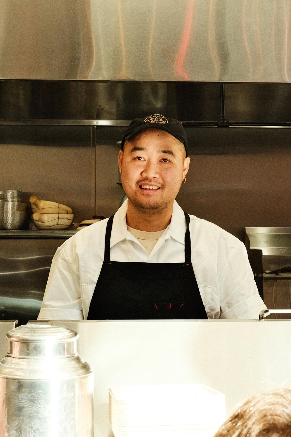 Chef Wedchayan “Deau” Arpapornnopparat stands behind the counter of his Atwater Village location of Holy Basil.