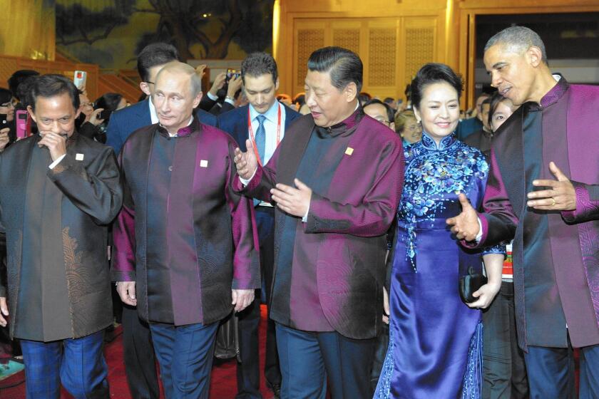World leaders at the APEC summit in Beijing include Brunei Sultan Sir Hassanal Bolkiah, left; Russian President Vladimir Putin; Chinese President Xi Jinping, with wife Peng Liyuan; and President Obama.