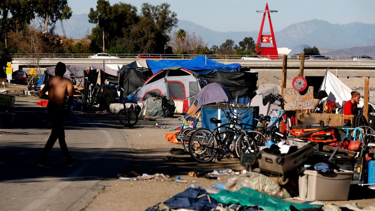 A homeless encampment along the Santa Ana River in Anaheim last month. Orange County officials are clearing the county's largest homeless encampment, but a judge has now asked for proof that the government agencies aren't criminalizing homelessness.