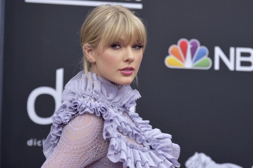 FILE - In this May 1, 2019 file photo, Taylor Swift arrives at the Billboard Music Awards at the MGM Grand Garden Arena in Las Vegas. Swift made a surprise performance at an iconic gay bar after releasing a song supporting the LGBTQ community. Swift celebrated Pride Month by appearing at the Stonewall Inn on Friday, June 14, 2019. She released her new tune Thursday called You Need to Calm Down, where she calls out those who attack the LGBTQ community.(Photo by Richard Shotwell/Invision/AP, File)