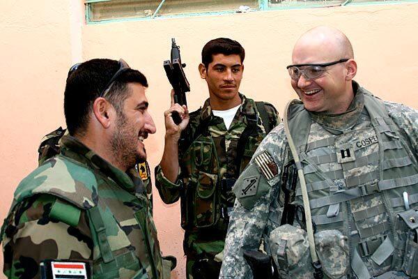 Saad Oraibi Ghafoori, left, in his heyday as a Son of Iraq leader shares a laugh with a member of the U.S. military.