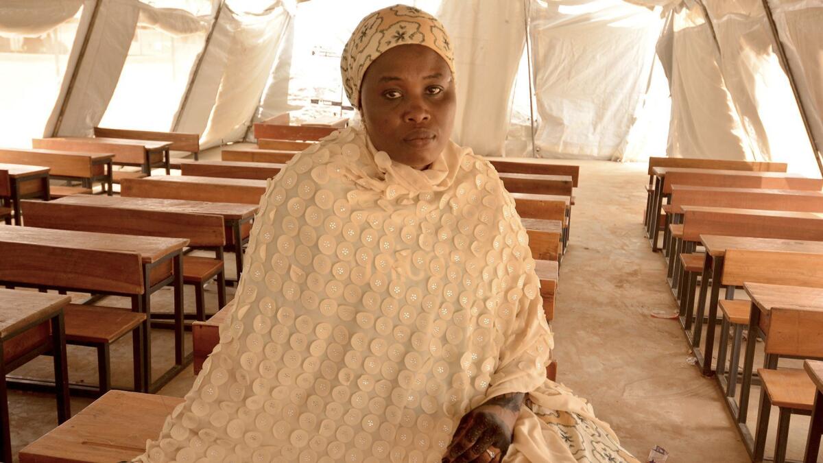 Boko Haram extremists in Bama, Nigeria, told Mariam Sandabe they would kill her if she did not stop teaching. She fled the town and now teaches in a displaced person's camp in Maiduguri.