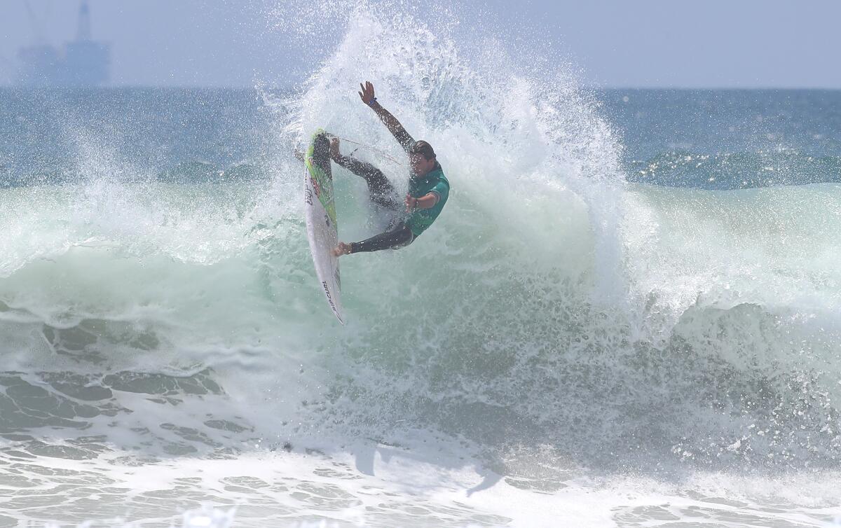 Local Crosby Colapinto completes a difficult off the lip as he advances in the U.S. Open of Surfing on Friday.