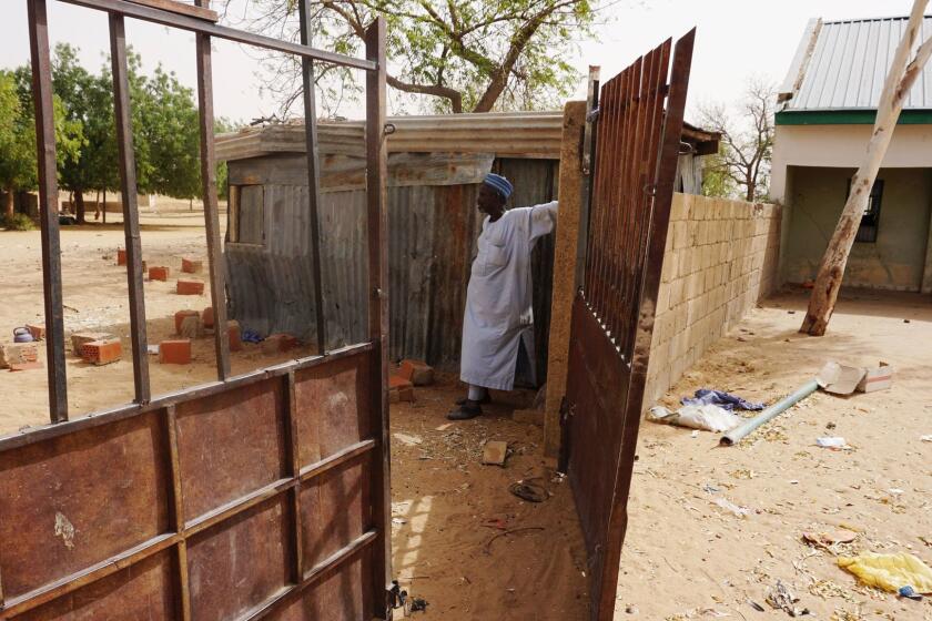 A watchman stands at the gate of the deserted student boarding of Government Girls Technical College, where 110 girls were kidnapped by Boko Haram Islamists at Dapchi town in northern Nigerian on February 28, 2018. Nigeria's government on March 1 said it had set up a committee to establish how Boko Haram jihadists managed to kidnap 110 girls from their school in the country's remote northeast. Members of the militant Islamist group stormed the Government Girls Science and Technical College in Dapchi, Yobe state, on February 19, nearly four years after a similar mass abduction in Chibok, Borno state. / AFP PHOTO / AMINU ABUBAKARAMINU ABUBAKAR/AFP/Getty Images ** OUTS - ELSENT, FPG, CM - OUTS * NM, PH, VA if sourced by CT, LA or MoD **