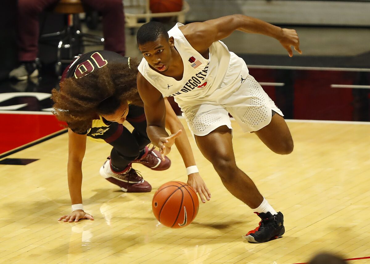 SDSU sophomore Lamont Butler steals the ball from Saint Katherine's Johnnie Coleman in their game last year.