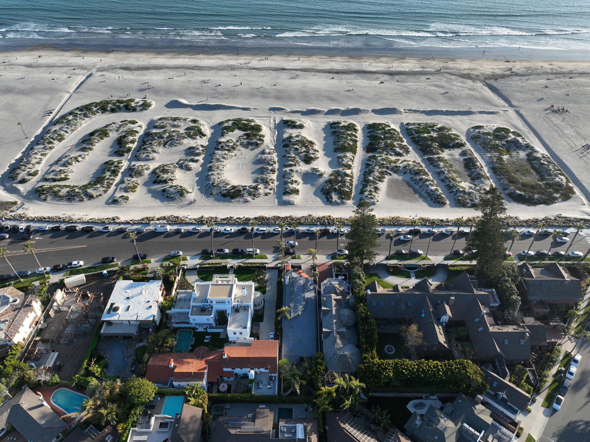 An aerial view of sand dunes on Coronado Beach and residential neighborhood in Coronado.