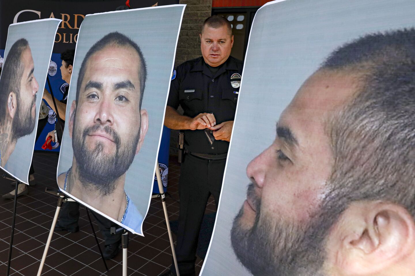 Garden Grove Police Cpl. Charles Starnes displays photos of suspect Zachary Castaneda