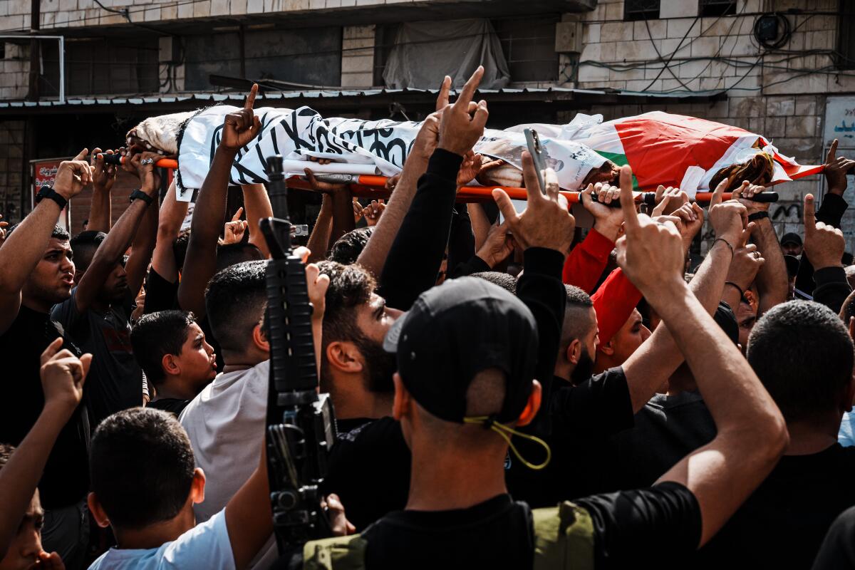 Mourners at a funeral procession for two men killed in an Israeli airstrike