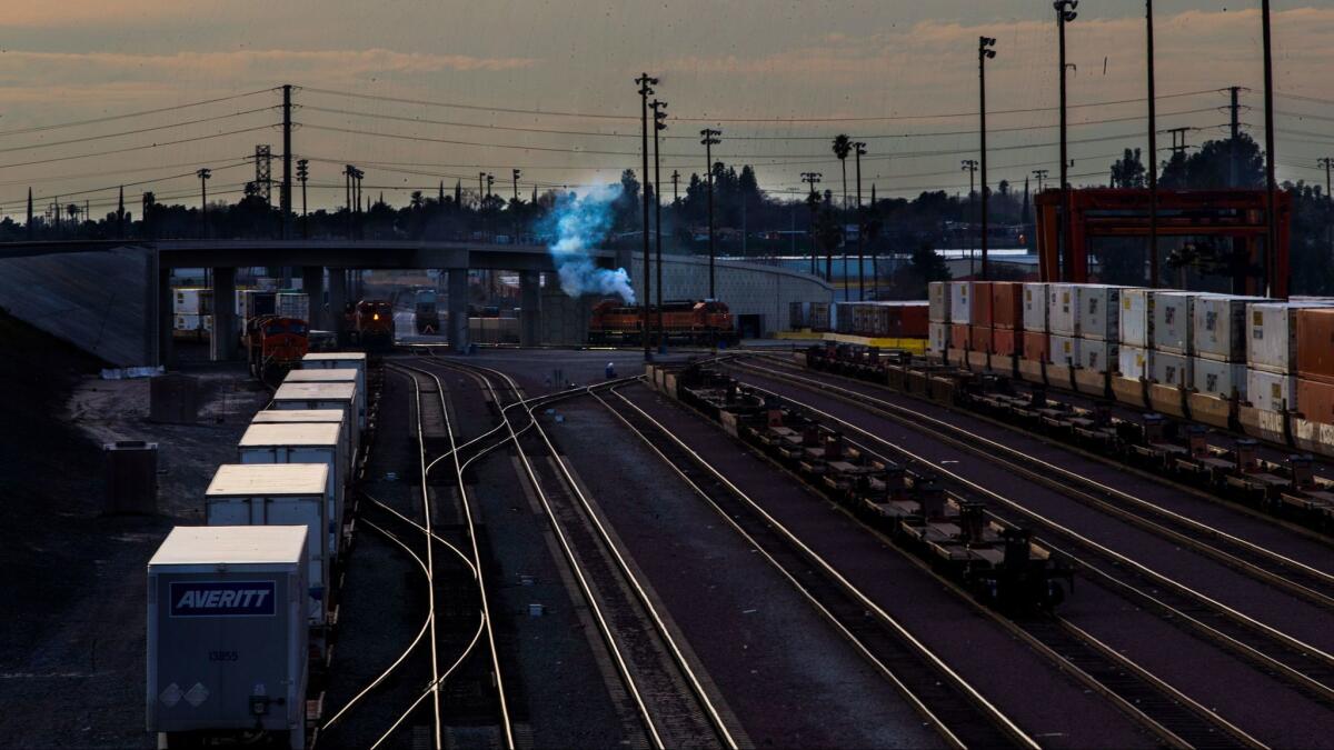 Smoke billows from a locomotive at a San Bernardino rail yard. Southern California air quality regulators delayed action on a pollution-reduction plan that relies on voluntary measures for ports, rail yards and other freight-handling facilities.