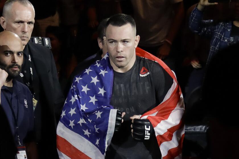 Colby Covington walks toward the octagon before a UFC welterweight fight against Robbie Lawler in Newark, N.J., on Aug. 3, 2019.