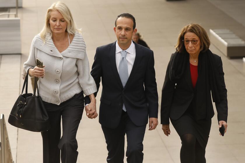 LOS ANGELES, CA - MARCH 12, 2020 Former Los Angeles city councilman Mitchell "Mitch" Englander, walks with his wife Jayne Englander, left, and his lead attorney Janet Levine, right, as they exit the Load Angeles Federal Courthouse after her appeared for a trial-setting conference Thursday morning March 12, 2020. The former Los Angeles city councilman is accused of obstructing an investigation into his allegedly accepting gifts from a businessman during trips to Las Vegas and Palm Springs and he faces seven federal criminal counts -- three of witness tampering, three for allegedly making false statements and a single count of scheming to falsify facts. (Al Seib / Los Angeles Times)