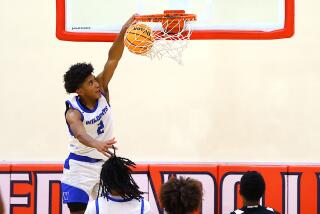 Jeremiah Hampton of Windward is one of four junior starters. He puts down dunk.