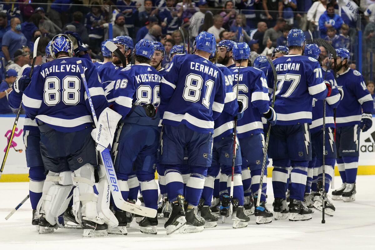 Tampa Bay Lightning goaltender Andrei Vasilevskiy (88) celebrates with his teammates after the team defeated the New York Rangers during Game 4 of the NHL hockey Stanley Cup playoffs Eastern Conference finals Tuesday, June 7, 2022, in Tampa, Fla. (AP Photo/Chris O'Meara)