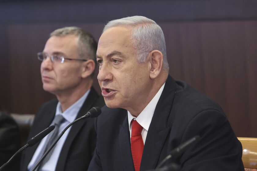 Israeli Prime Minister Benjamin Netanyahu, right, chairs the weekly cabinet meeting at the Prime Minister's office in Jerusalem, Sunday March 5, 2023. (Gil Cohen-Magen/Pool via AP)
