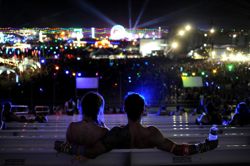 Martin Antosz and his girlfriend, Suzie Harty, visiting from Minneapolis, take in the carnival from the grandstand at the EDC in Las Vegas.